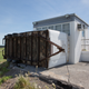A trailer at the NASA news center, blown over.